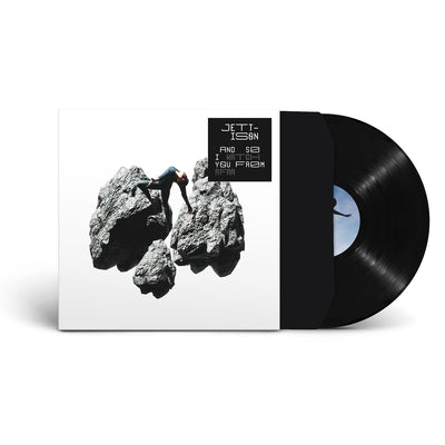 White vinyl sleeve with a solid black vinyl sticking out of the sleeve against a white background. The vinyl cover features three large rocks in grey, and a person is standing on one of them. The right corner has a black square, the text inside says "jettison", "and so I watch you from afar". 
