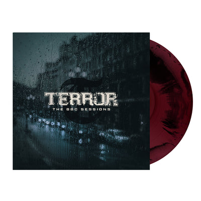 Image of terror- the bbc sessions vinyl sleeve with a black and maroon colored vinyl against a white background. The terror artwork features a photo of a street with cars lined up against the side of the street. There is a large building next to where the cars are parked. there is rain all over the cover, like this was photographed from the inside of a window. the image is a blue/grey color. Across the front in white text reads terror- the bbc sessions.