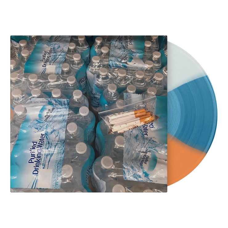 Image of a vinyl sleeve with a tri-color white, blue, and orange vinyl sticking out of the sleeve. The sleeve is an image of four cases of bottled water, with cigarettes in a clear plastic baggie sitting on top of one of the cases of water.