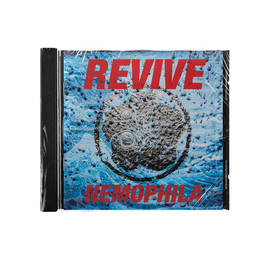 CD cover for the U.S. Version of Revive by Nemophila, with REVIVE in large red letters at the top, Nemophila below, and a blue background featuring bubbles and a dark circular object at the center. Track list is not included.