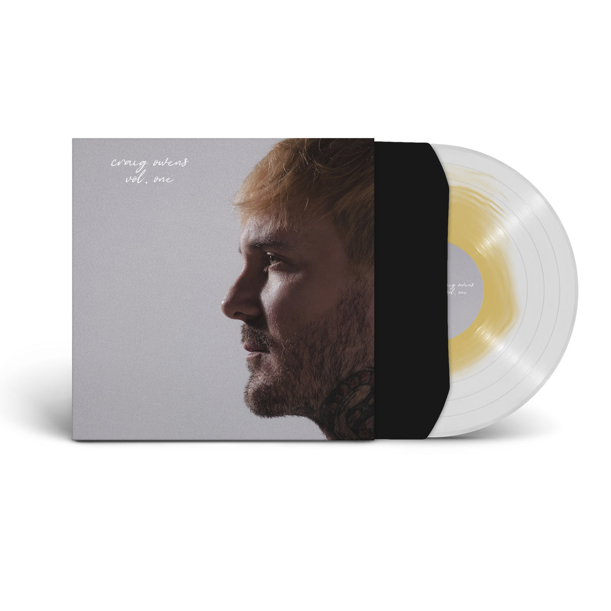 A limited edition clear vinyl by Craig Owens, partly out of a black sleeve, sits beside an album cover showing a blond, bearded man in profile on gray with the text "craig owens vol. one.
