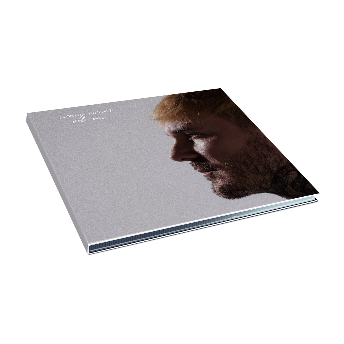A square album cover for Craig Owens features a bearded, light-haired man in profile on a plain background, with white handwritten text "Craig Owens Volume One" in the top left corner. The tracklist is not displayed.
