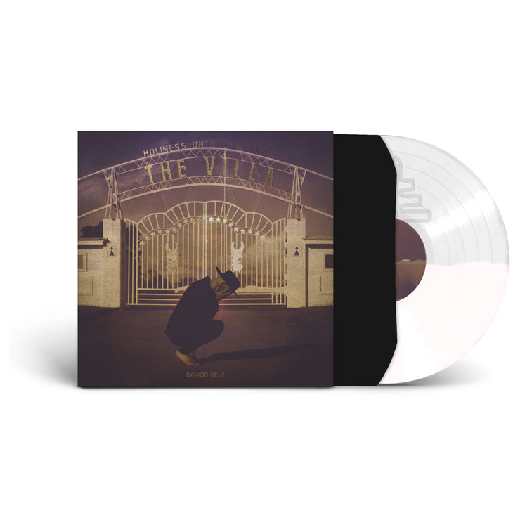 image of the vinyl LP with the vinyl exposed to show color. Color of vinyl is Half Clear and Half White. Album Cover shows a man crouched down holding his head in his hands out front of an amusement park.