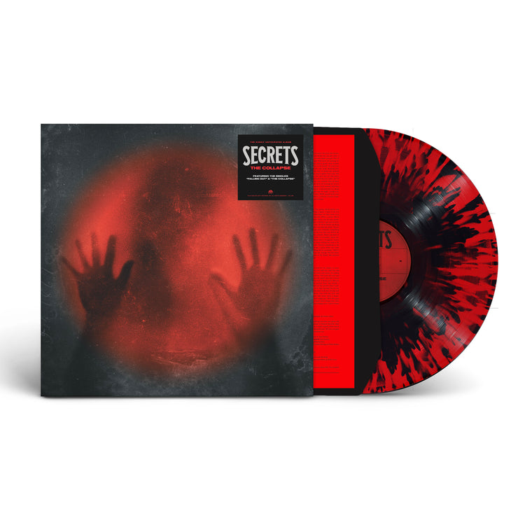Image of Secrets- the collapse vinyl cover with a red with black splatter vinyl sticking halfway out of the sleeve. The album art features a black image with a red lit circle in the center. the silhouette of a head is in the middle, with two hands pressed up against the red light. the hype sticker in the right top corner reads "secrets, the collapse"