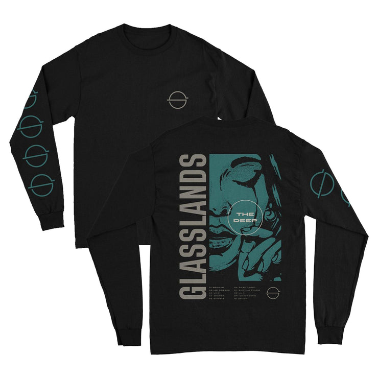 Front and back of black longsleeve against white background. The left chest features the glasslands symbol of a circle with a line through the center horizontally in a greyish white. The right sleeve features this same symbol multiple times descending down the sleeve in blue. The back says glasslands and there is a graphic of a woman's face up close crying and wiping a tear away. On top of this in a white circle reads "the deep". There is small white text below this.